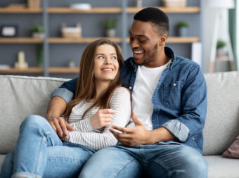 Domestic Leisure. Romantic Interracial Couple Relaxing At Home Together
